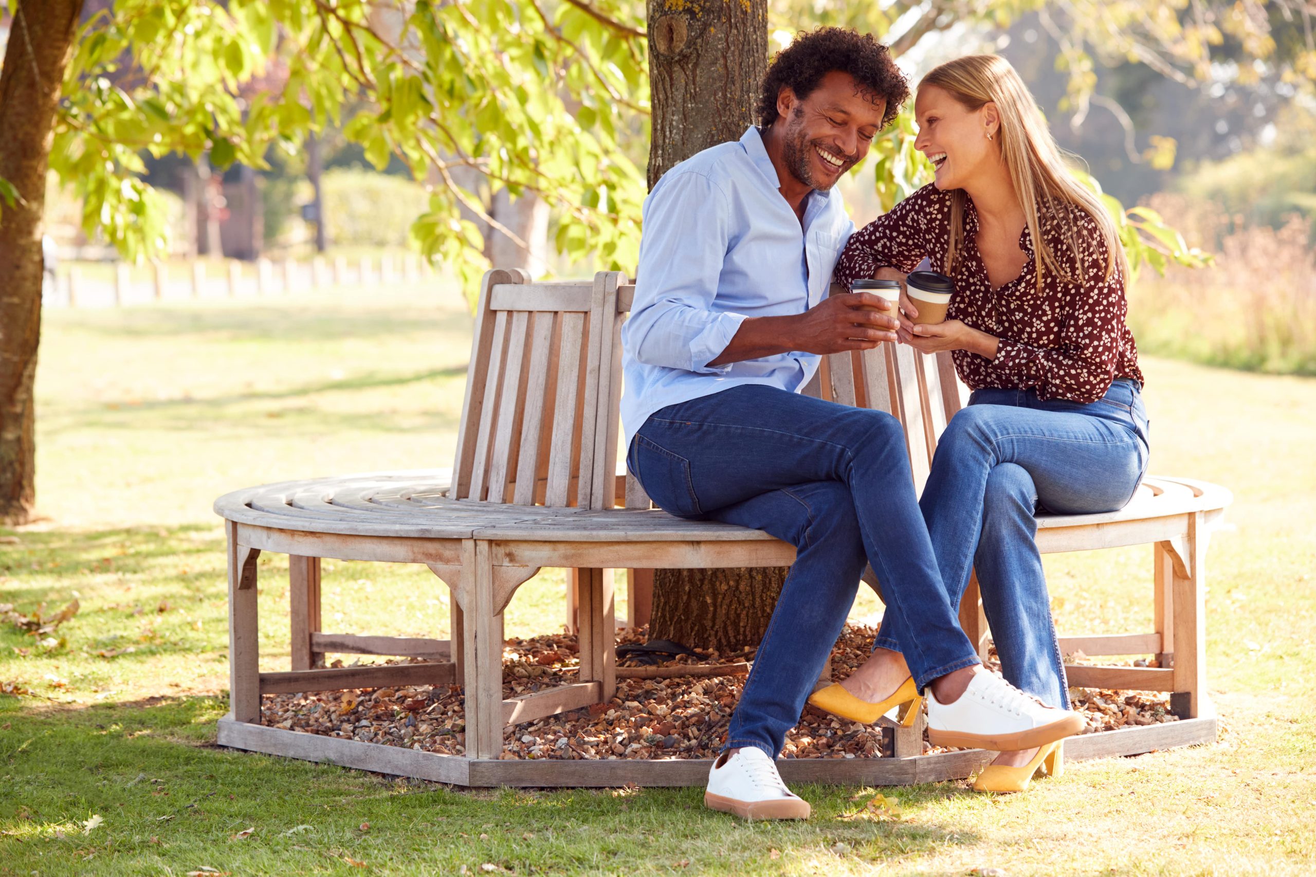 Couple Sitting on Bench Laughing