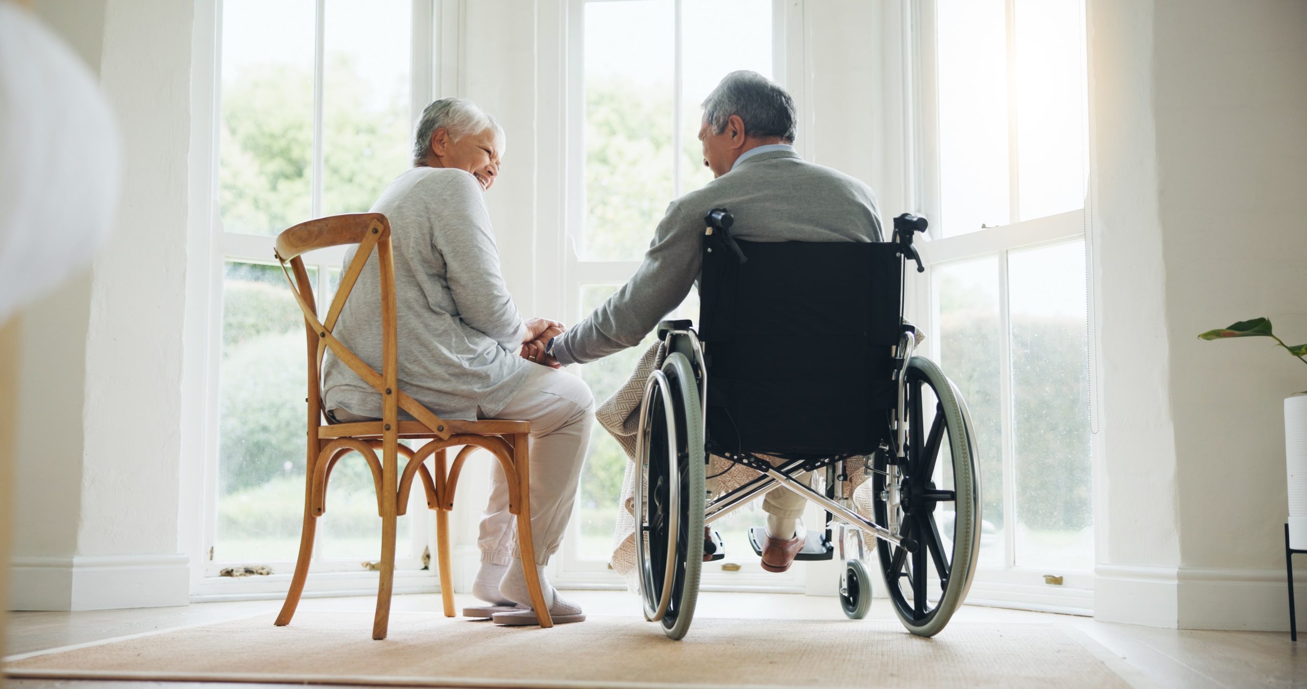 Man in Wheelchair sitting with a Woman